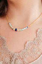 Woman wearing a beaded gold chain necklace